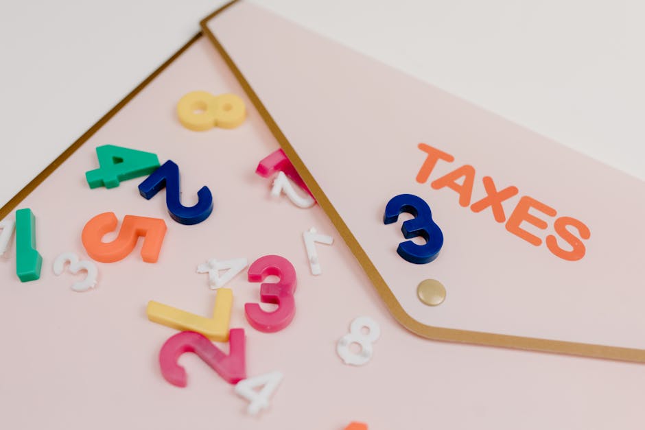Bright plastic numbers scattered over a tax envelope, symbolizing accounting and finance concepts.