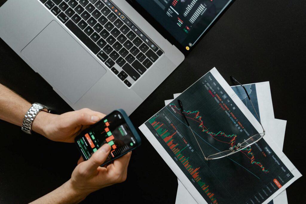 Person viewing stock market charts on a phone