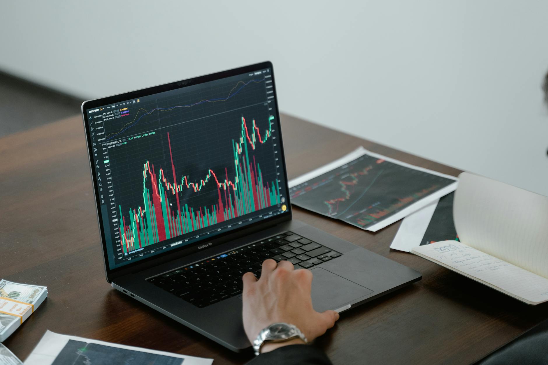 Laptop showing investment portfolio and financial charts