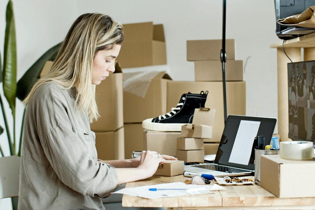 Person managing an ecommerce dropshipping store on laptop