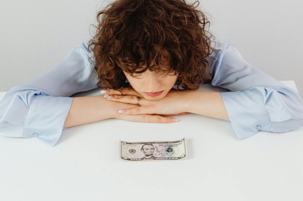 Person looking stressed at financial documents representing money anxiety