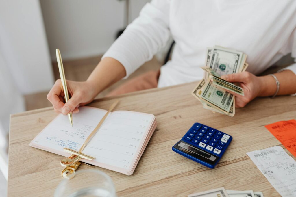 Person reviewing monthly bills and budget