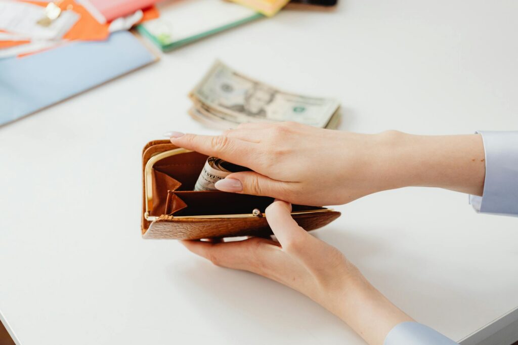 Person counting money representing a pay rise and salary increase