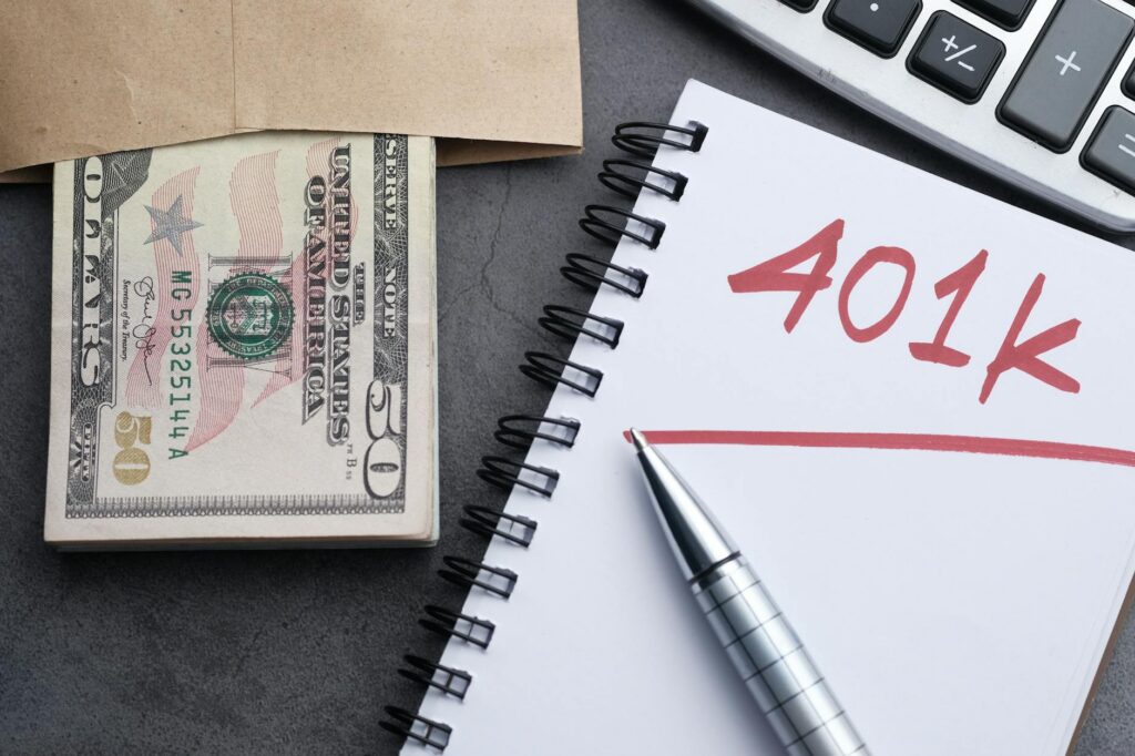 Person planning retirement savings with documents and calculator