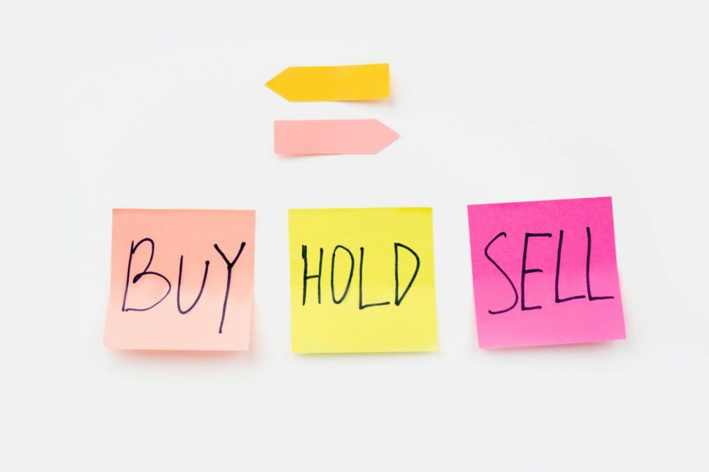 Person reviewing long-term investment charts representing buy and hold strategy