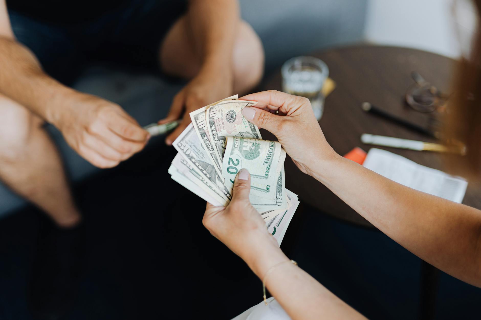 Person reviewing monthly bills and budgeting to pay off debt faster