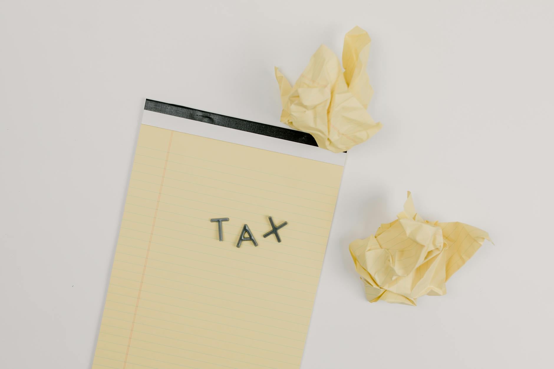 Person stressed while filling out tax paperwork
